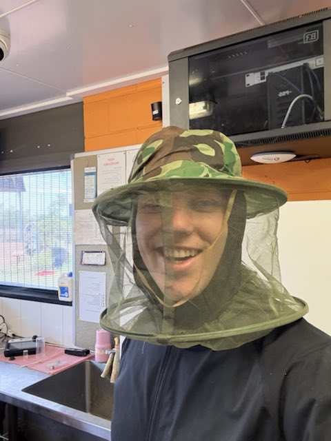 Charlie wearing a protective bee veil while working